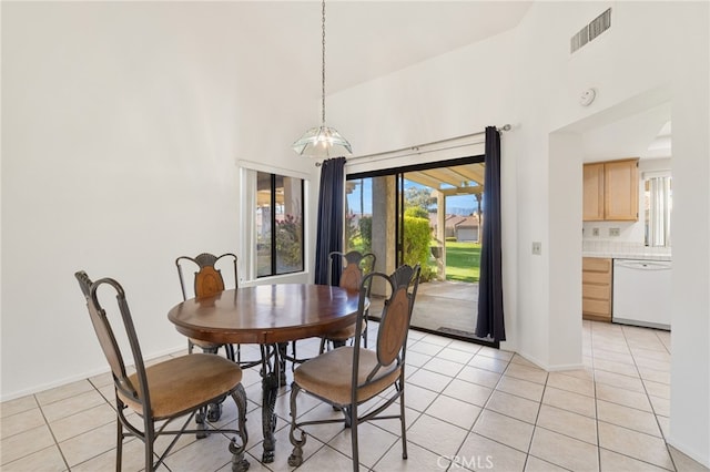 tiled dining area with high vaulted ceiling