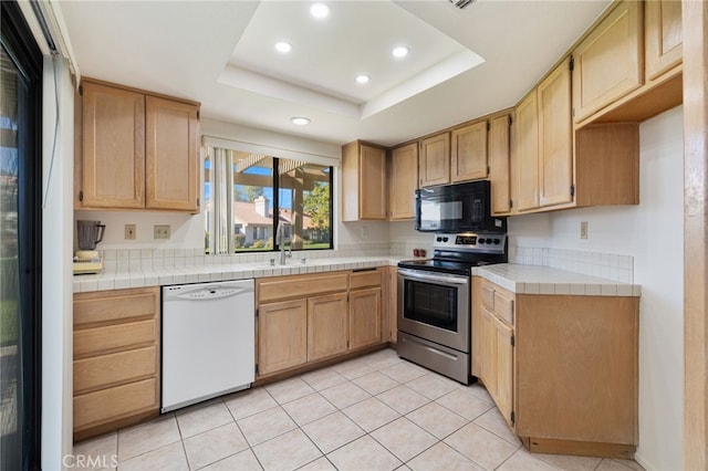 kitchen with electric stove, a tray ceiling, white dishwasher, and black microwave