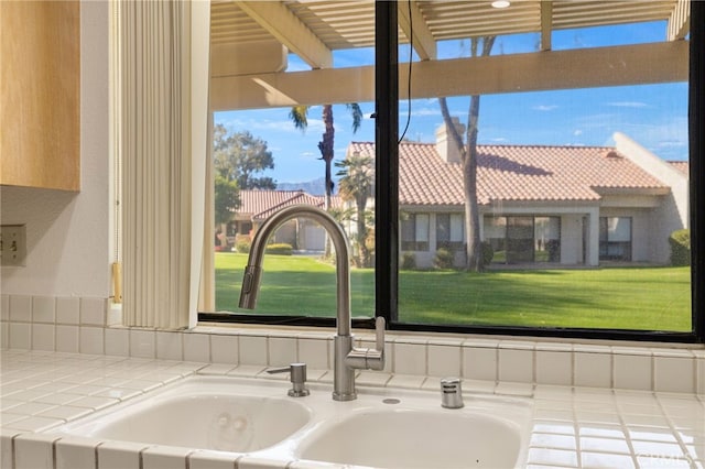 room details featuring tile counters and sink