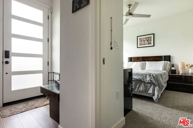 bedroom with light hardwood / wood-style floors and ceiling fan