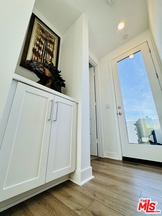 doorway with light hardwood / wood-style floors