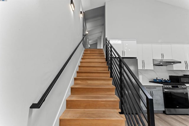 staircase with hardwood / wood-style floors