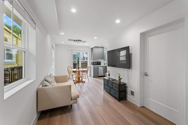 living room featuring light hardwood / wood-style flooring and a healthy amount of sunlight