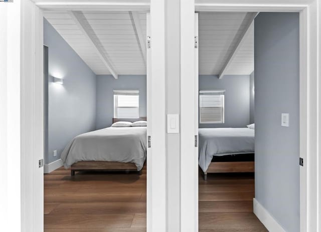 bedroom featuring wood-type flooring, vaulted ceiling with beams, and wooden ceiling