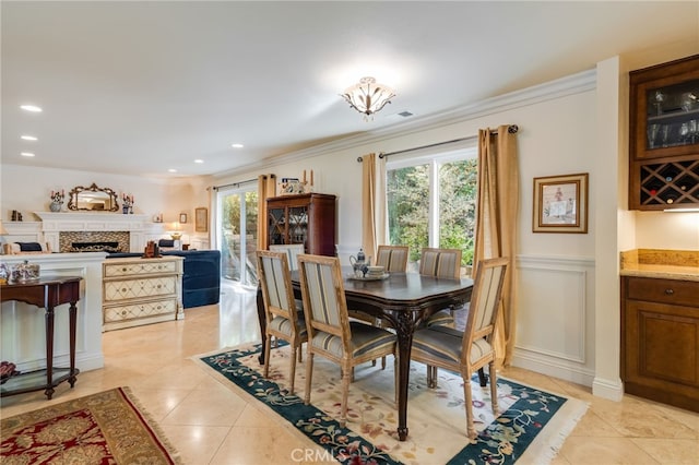 dining room with ornamental molding and light tile patterned floors