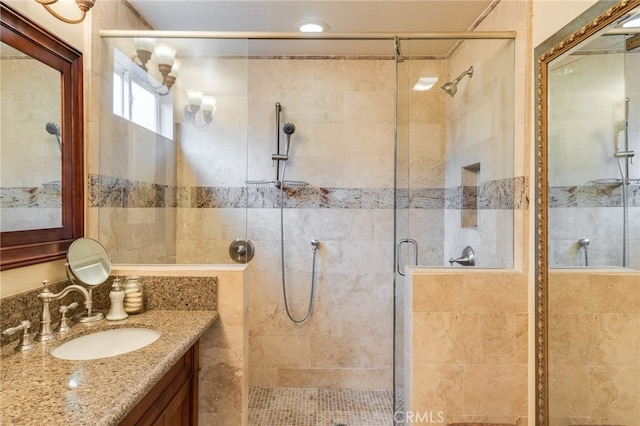 bathroom with an enclosed shower and vanity