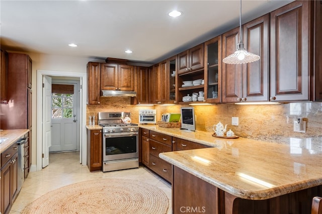 kitchen with appliances with stainless steel finishes, decorative light fixtures, a kitchen breakfast bar, kitchen peninsula, and light stone countertops