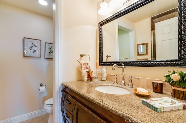 bathroom featuring vanity, toilet, and tile patterned flooring