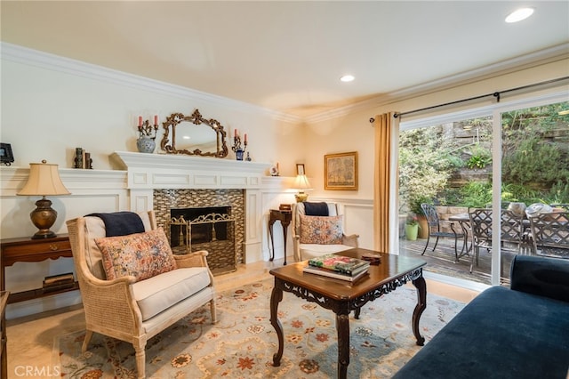 living room with ornamental molding and a tile fireplace