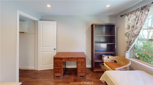 bedroom with dark hardwood / wood-style floors