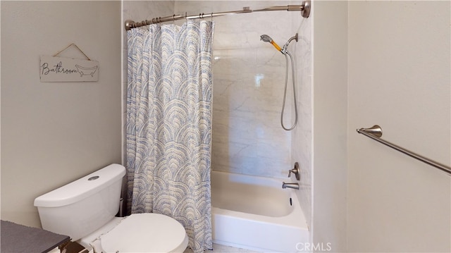 bathroom featuring shower / tub combo and toilet