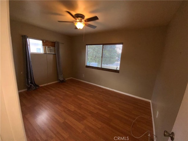 unfurnished room with ceiling fan and dark hardwood / wood-style flooring