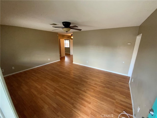 spare room featuring ceiling fan and hardwood / wood-style floors