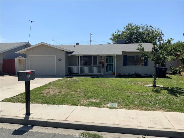 ranch-style home with a front lawn, covered porch, and a garage