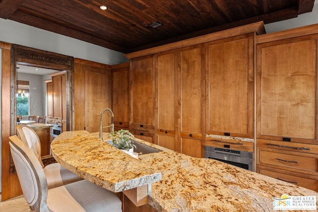 dining space featuring wooden ceiling and sink