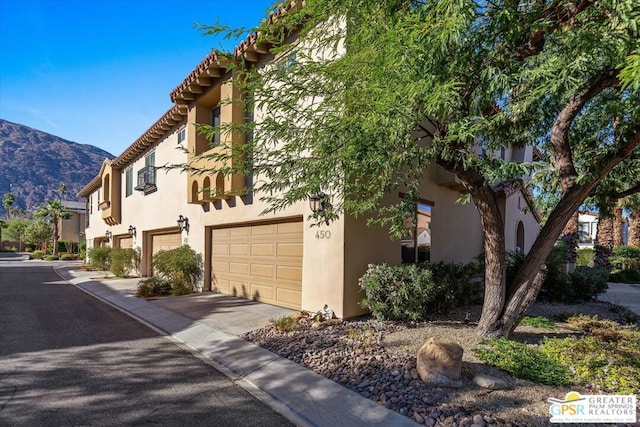 exterior space with a mountain view and a garage