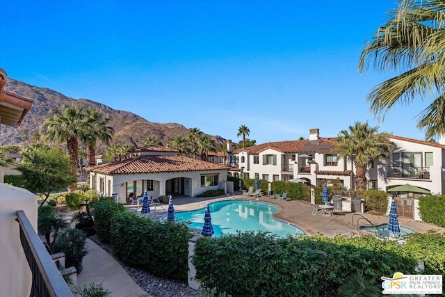 view of pool with a patio area and a mountain view