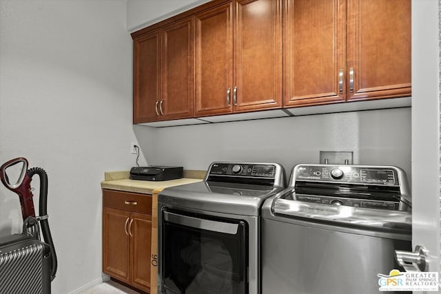 washroom featuring cabinets and independent washer and dryer