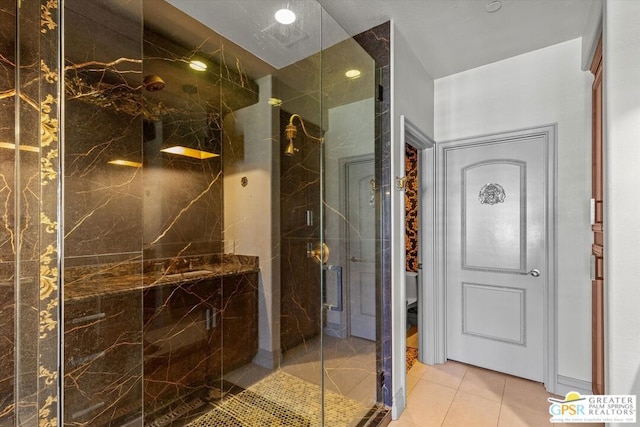 bathroom featuring tile patterned flooring, toilet, and a shower with shower door