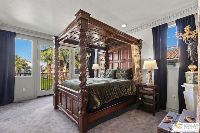 carpeted bedroom featuring a textured ceiling and access to outside