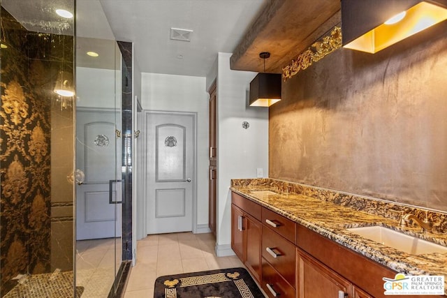 bathroom featuring tile patterned floors, vanity, and a shower with shower door