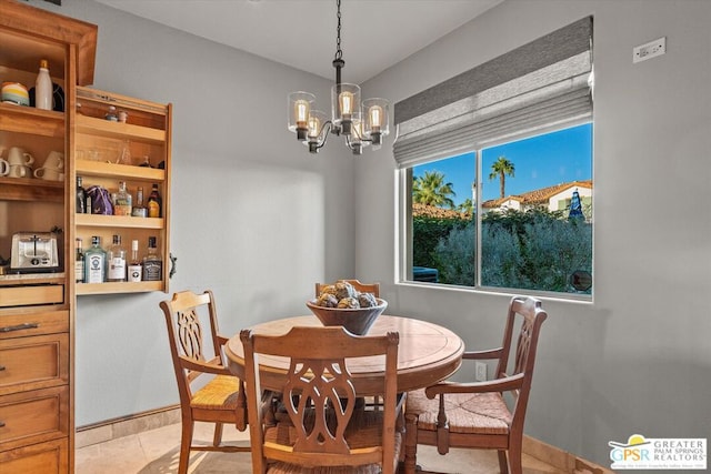 tiled dining space featuring an inviting chandelier