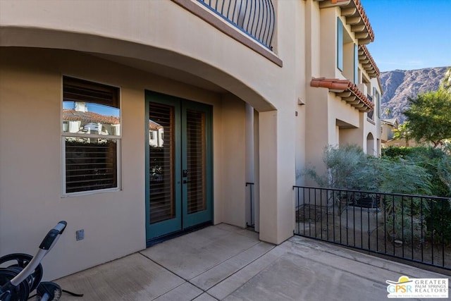 view of patio featuring a mountain view and french doors