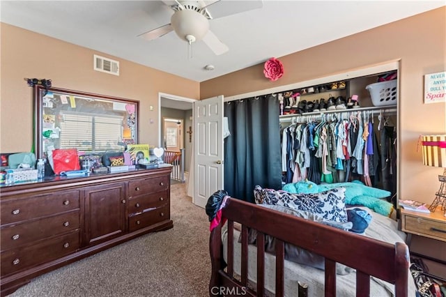 carpeted bedroom with a closet and ceiling fan