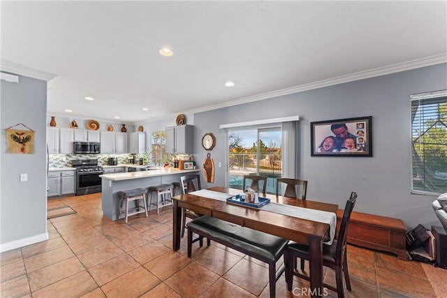 dining space featuring baseboards, ornamental molding, and recessed lighting