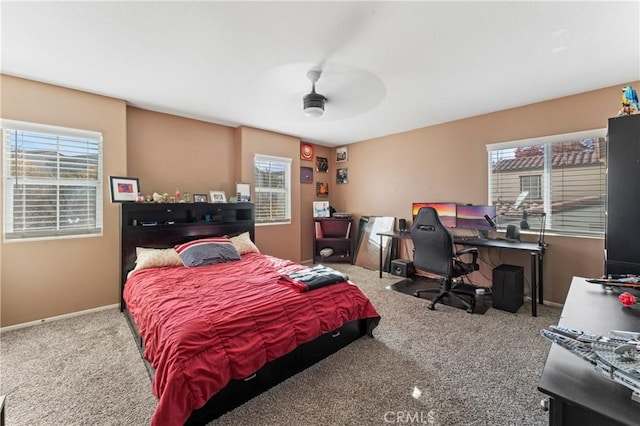 bedroom with carpet, baseboards, and a ceiling fan