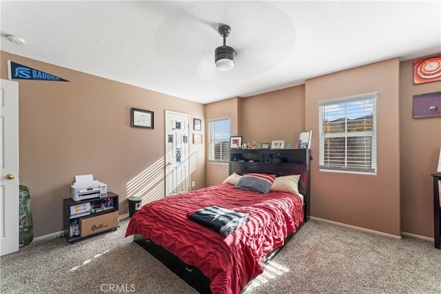 bedroom featuring carpet flooring, baseboards, and multiple windows