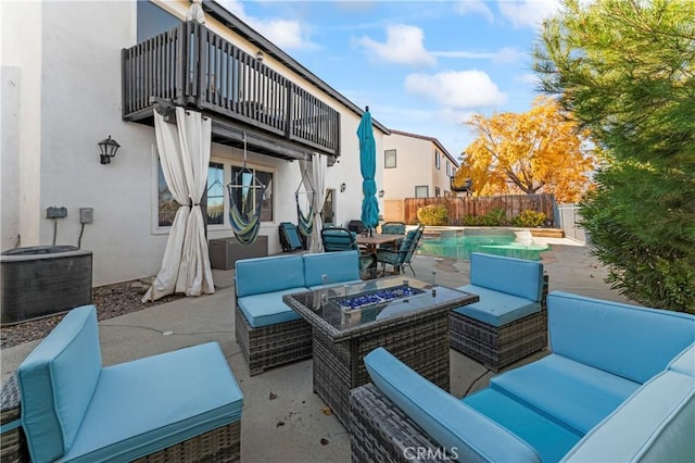 741 Camino Real Ave, Palmdale, CA 93551 - fenced backyard with an outdoor living space with a fire pit, a balcony, a patio, and cooling unit