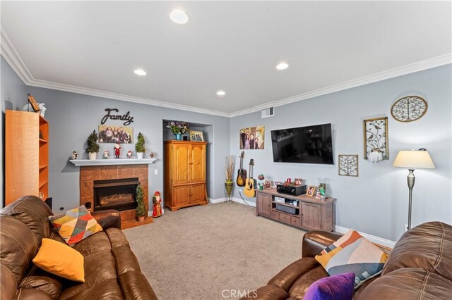 living room featuring a tile fireplace, light carpet, and ornamental molding