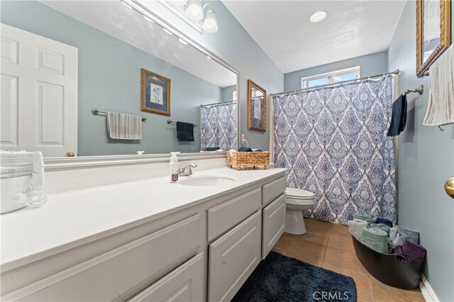 bathroom featuring tile patterned floors, toilet, and vanity