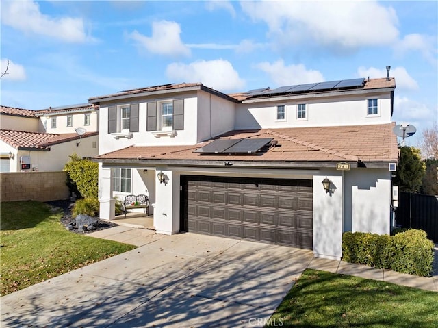 traditional-style home featuring stucco siding, roof mounted solar panels, fence, driveway, and a front lawn