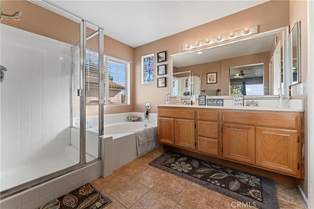 bathroom featuring double vanity, a sink, a shower stall, a bath, and tile patterned floors