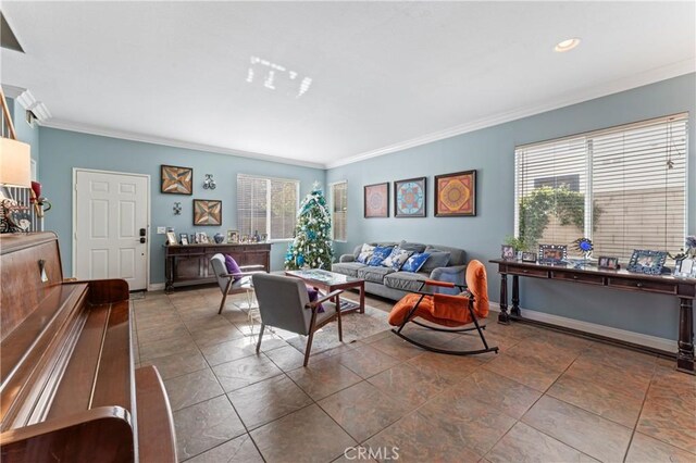 living room featuring a healthy amount of sunlight, tile patterned flooring, baseboards, and crown molding