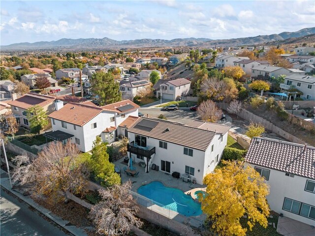 birds eye view of property with a mountain view and a residential view