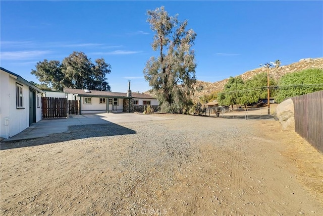 view of yard with a mountain view and a patio