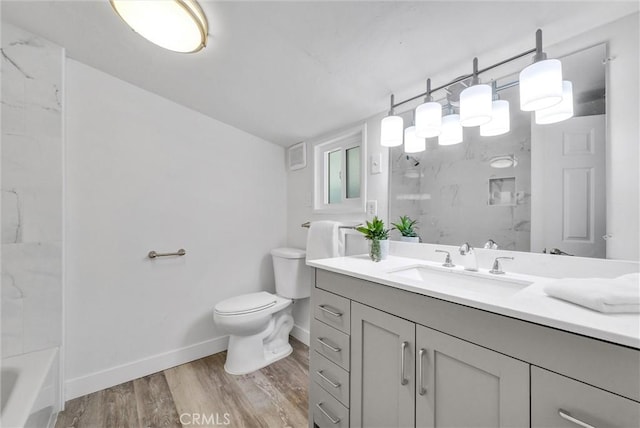 bathroom featuring vanity, hardwood / wood-style flooring, and toilet