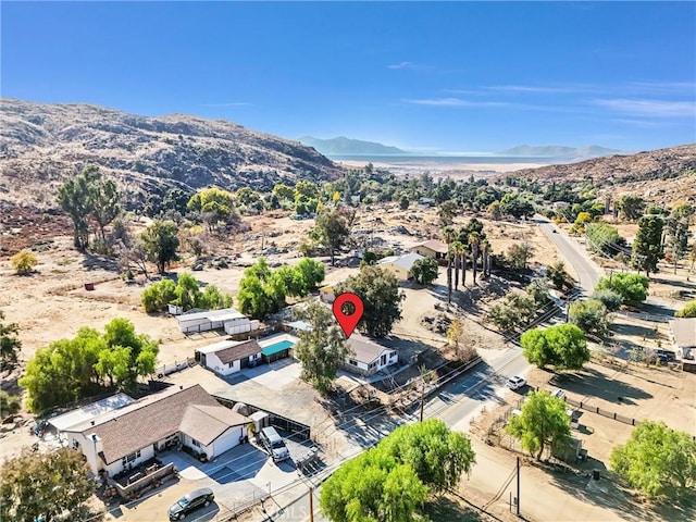 birds eye view of property with a mountain view