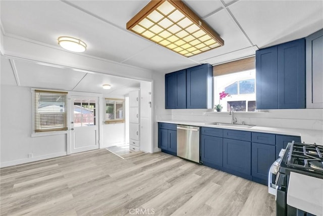 kitchen with stainless steel appliances, light hardwood / wood-style flooring, blue cabinets, and sink