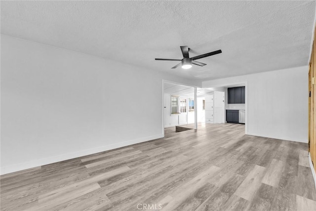 unfurnished living room with ceiling fan, light wood-type flooring, and a textured ceiling