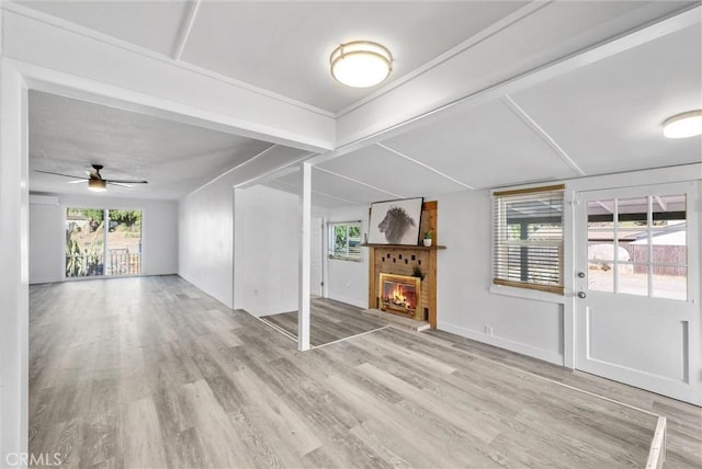 unfurnished living room with light wood-type flooring and ceiling fan