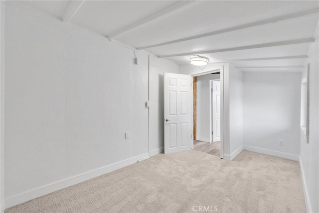 carpeted spare room with beam ceiling