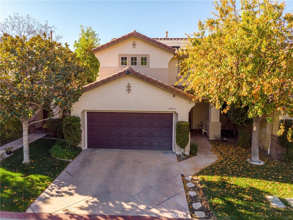 mediterranean / spanish-style home featuring a garage