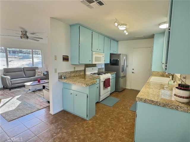 kitchen with white appliances, ceiling fan, and sink