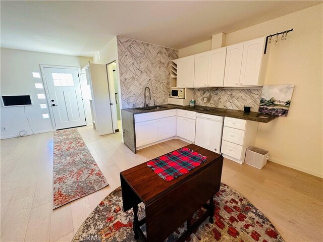 kitchen featuring sink, white cabinets, white appliances, and light hardwood / wood-style flooring