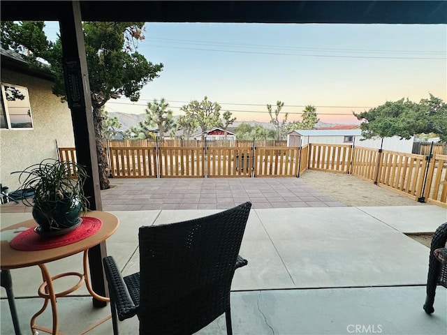 view of patio terrace at dusk