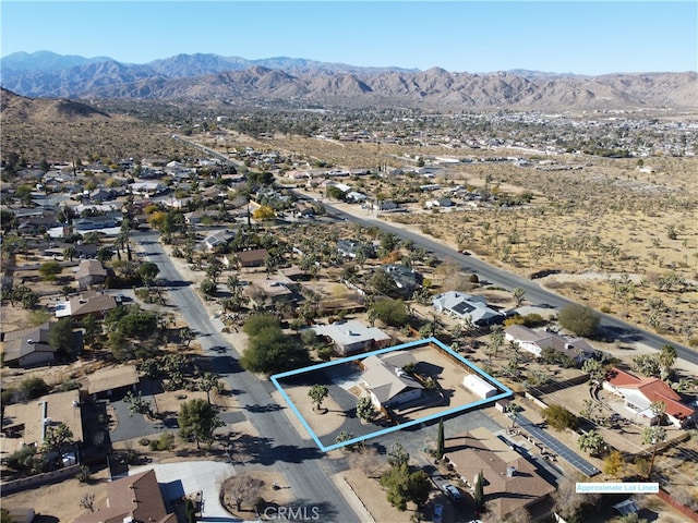 birds eye view of property featuring a mountain view